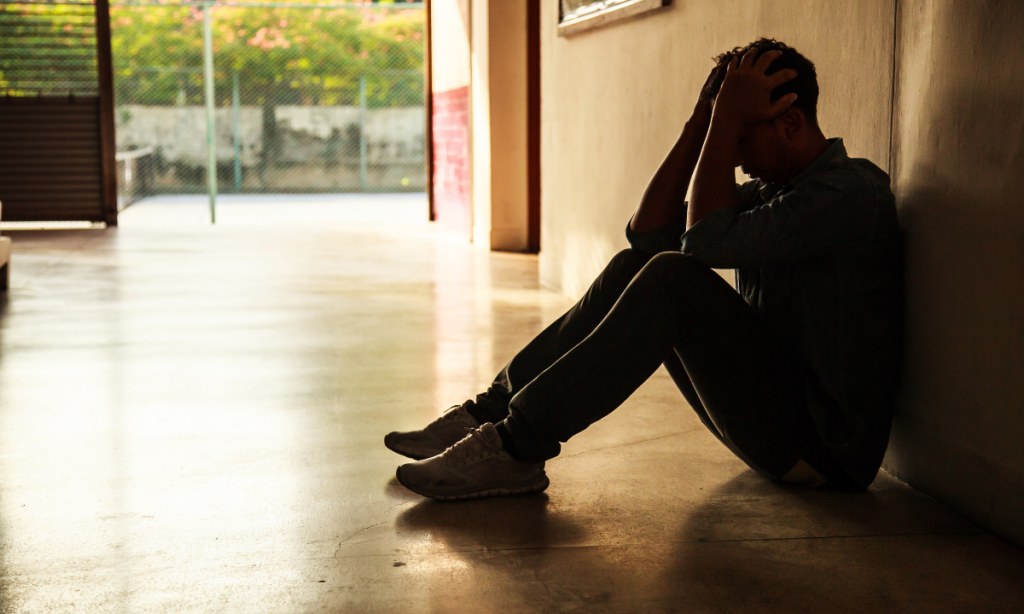 Man holding hands to his face in crisis.